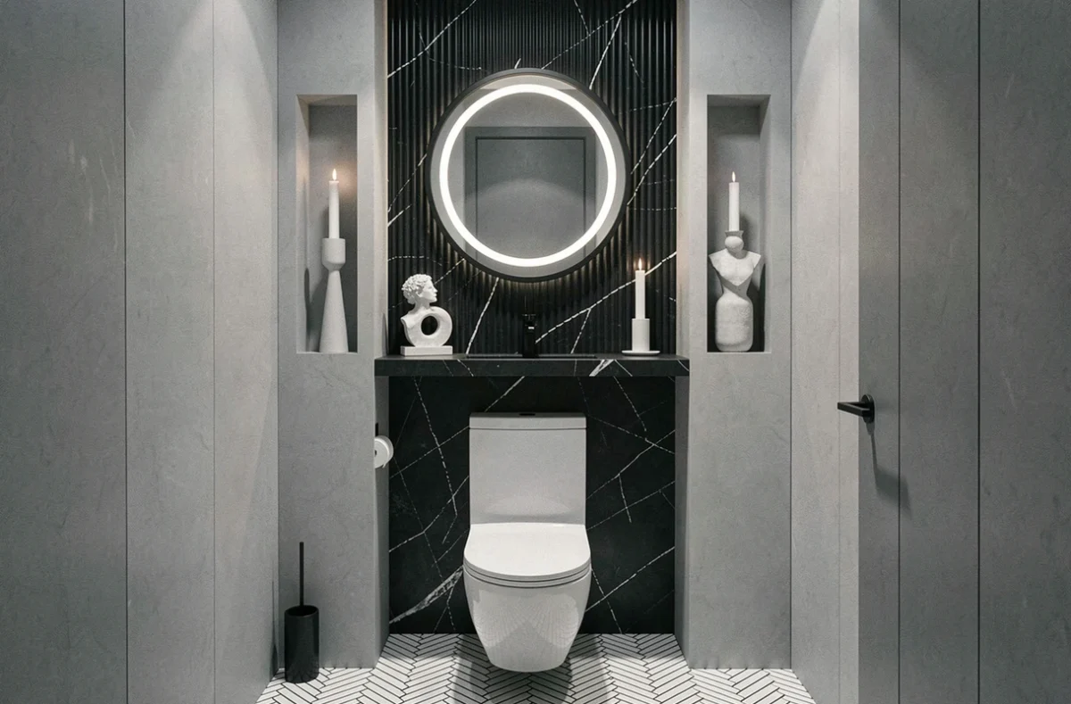 WC suspendu dans des toilettes de style hôtel cinq étoiles avec panneau en marbre noir et sol en mosaïque chevrons